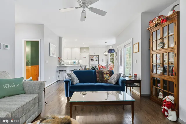 a living room with furniture and a book shelf