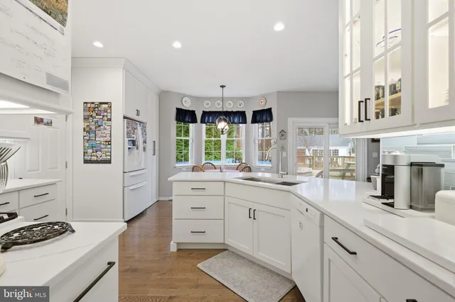 a kitchen with stainless steel appliances kitchen island granite countertop a sink stove and cabinets