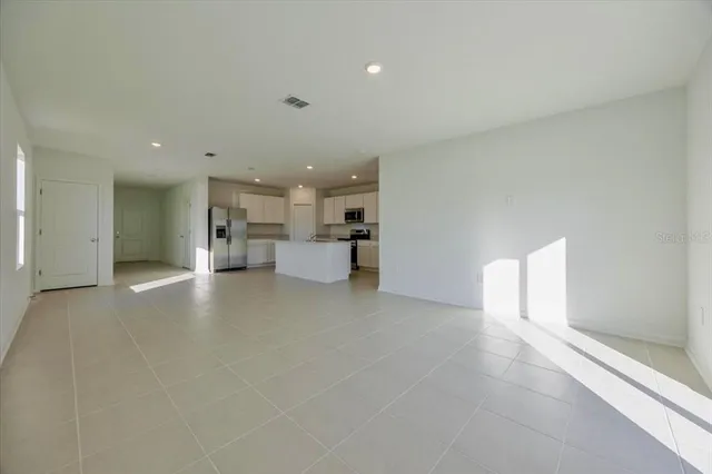 a view of a kitchen with a sink and a refrigerator cabinets