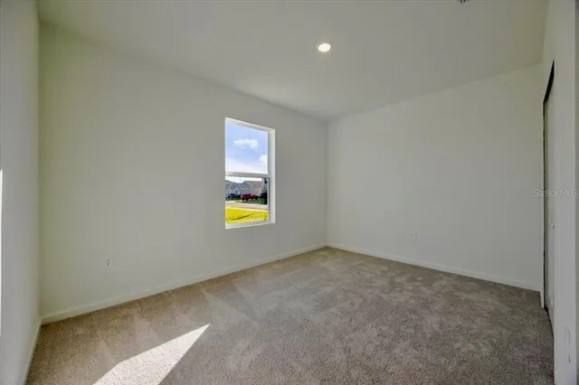 a view of an empty room and a window