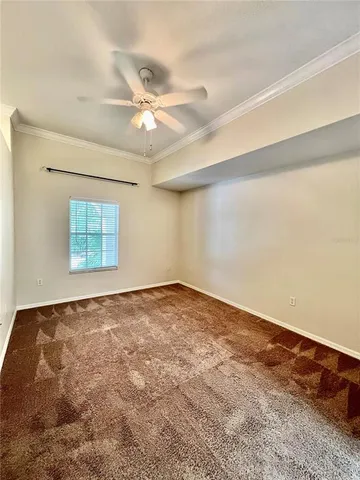 a view of a room with a ceiling fan