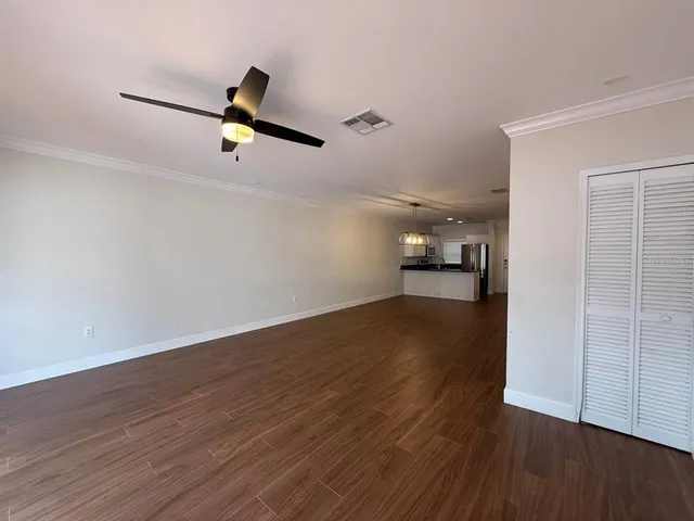 a view of empty room with wooden floor