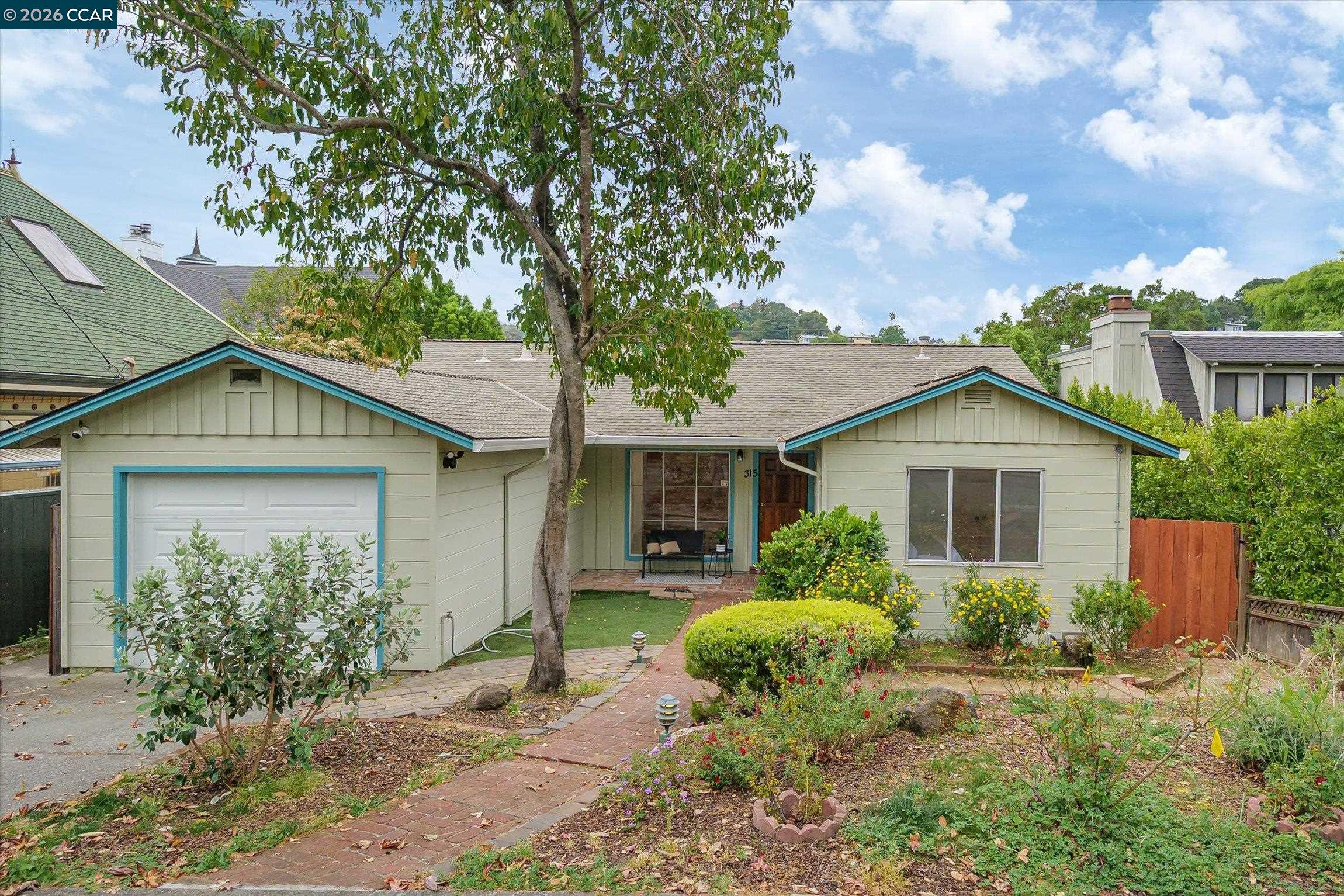 a view of a house with a yard and plants