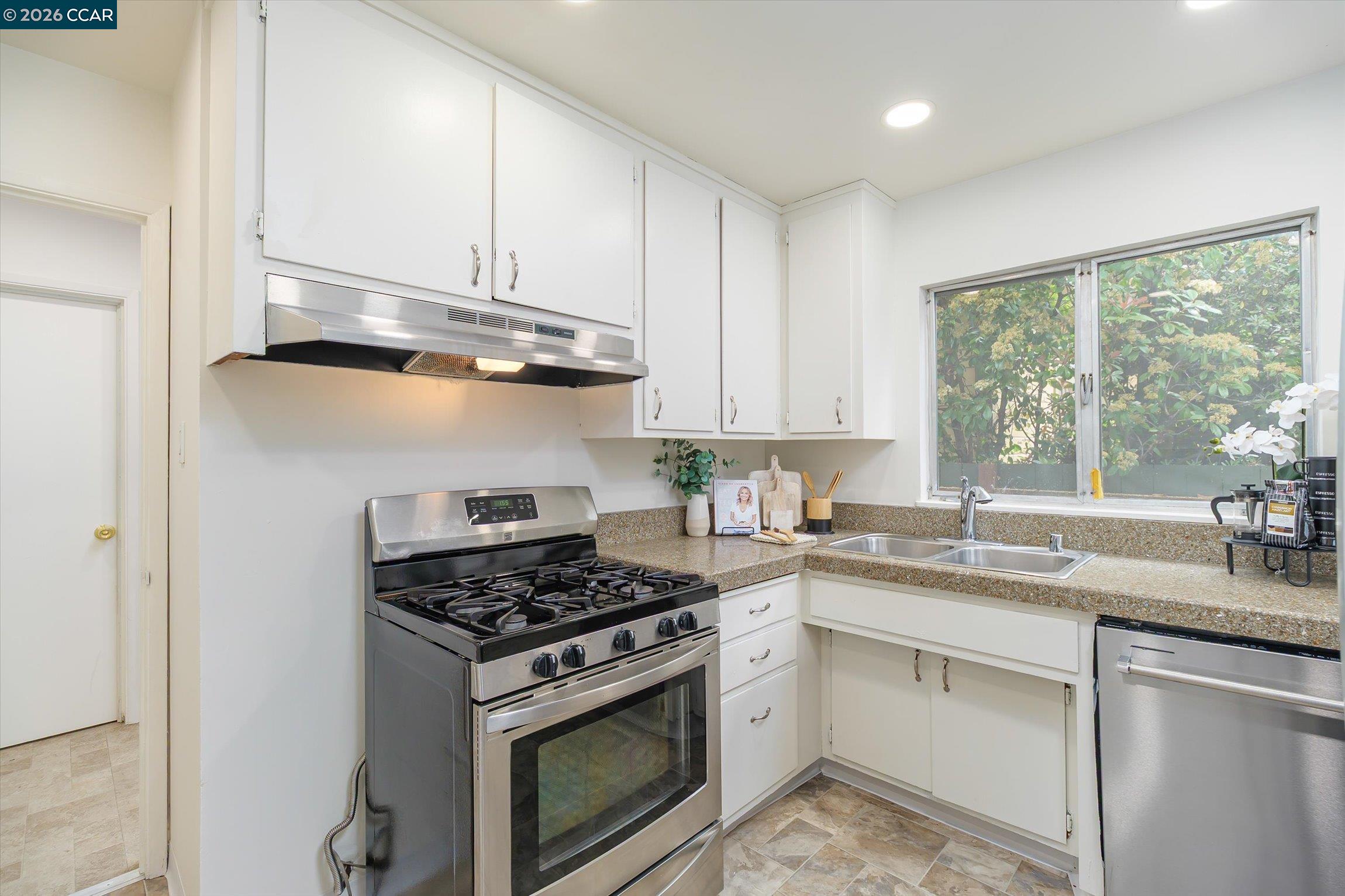 315 Forbes Avenue San Rafael, CA 94901 - Photo 11 of 28 a kitchen with granite countertop stainless steel appliances white cabinets granite counter tops and a window