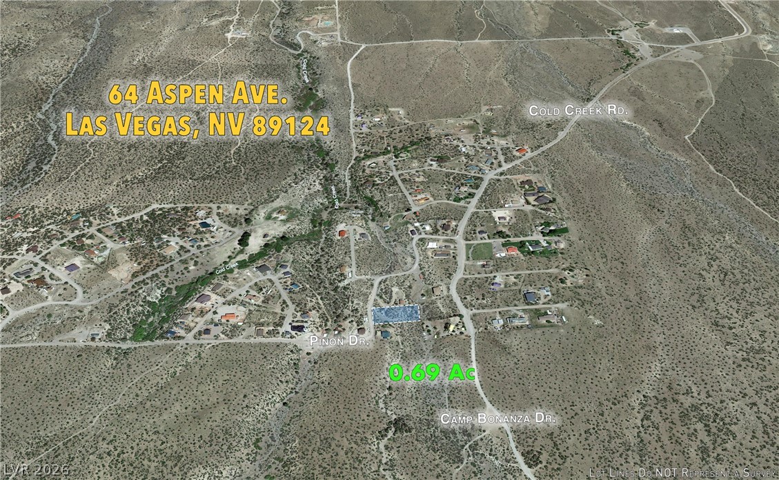 64 Aspen Road Las Vegas, NV 89124 - Photo 2 of 8 An aerial perspective reveals a desert landscape with scattered residential development and a defined lot for sale.