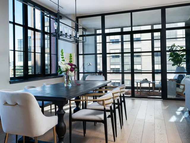 a view of a dining room with furniture and a potted plant