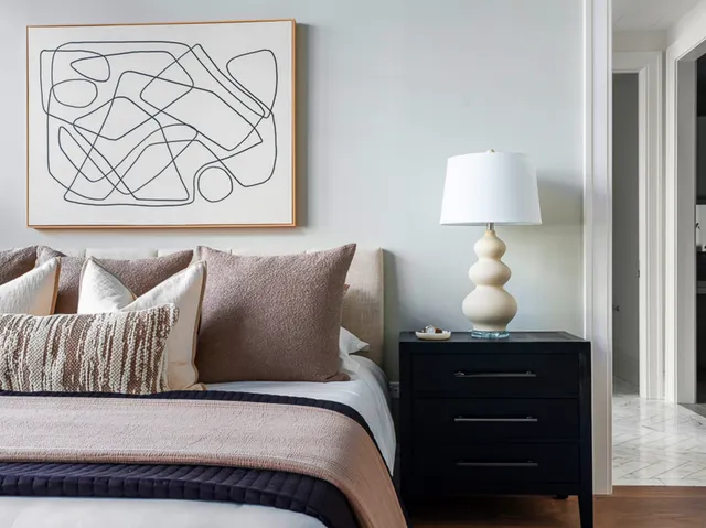 a bedroom with a bed and lamp