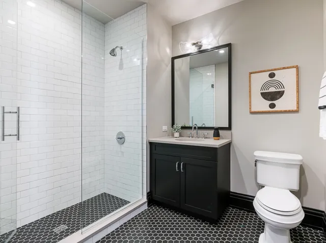 a bathroom with a sink toilet and shower