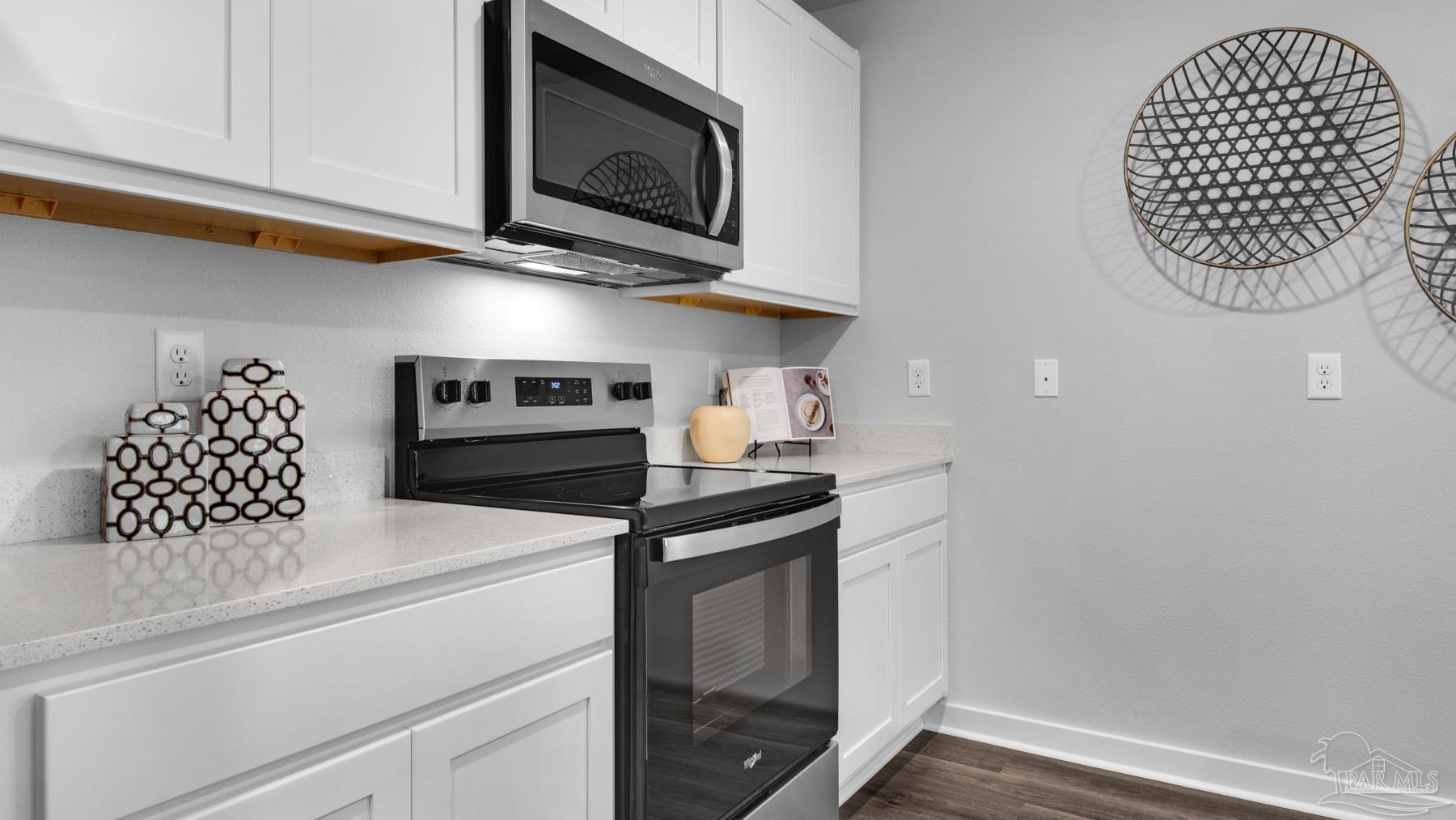 8 Spoonbill Street Cantonment, FL 32533 - Photo 14 of 38 a kitchen with a stove and a microwave