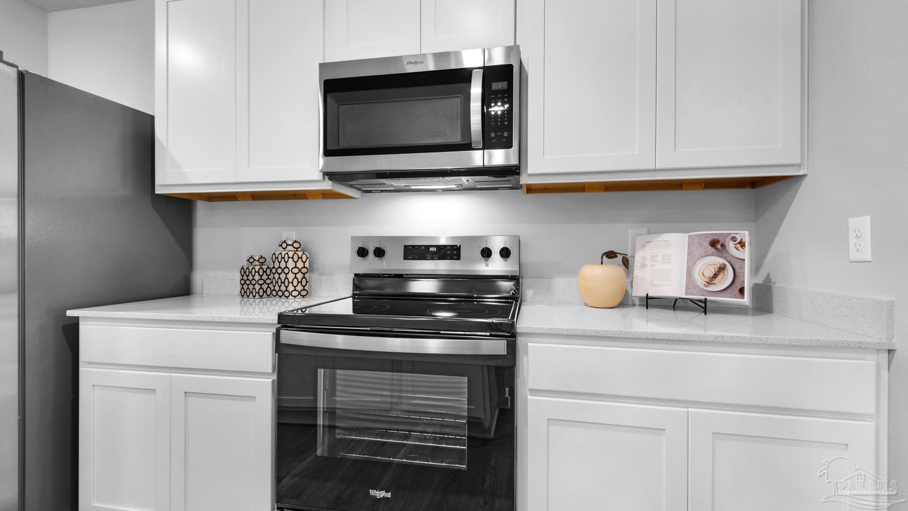 8 Spoonbill Street Cantonment, FL 32533 - Photo 15 of 38 a kitchen with stainless steel appliances white cabinets and a stove top oven