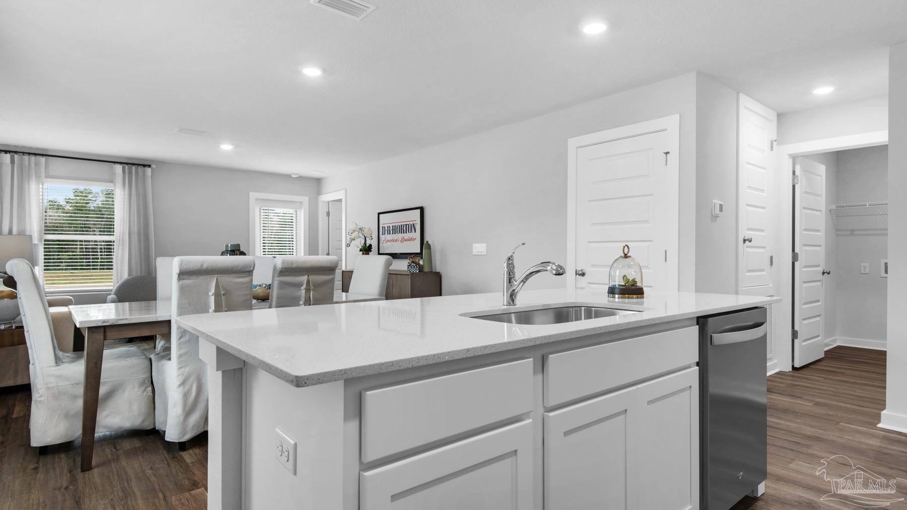 8 Spoonbill Street Cantonment, FL 32533 - Photo 16 of 38 a kitchen with stainless steel appliances granite countertop a sink and dishwasher with wooden floor
