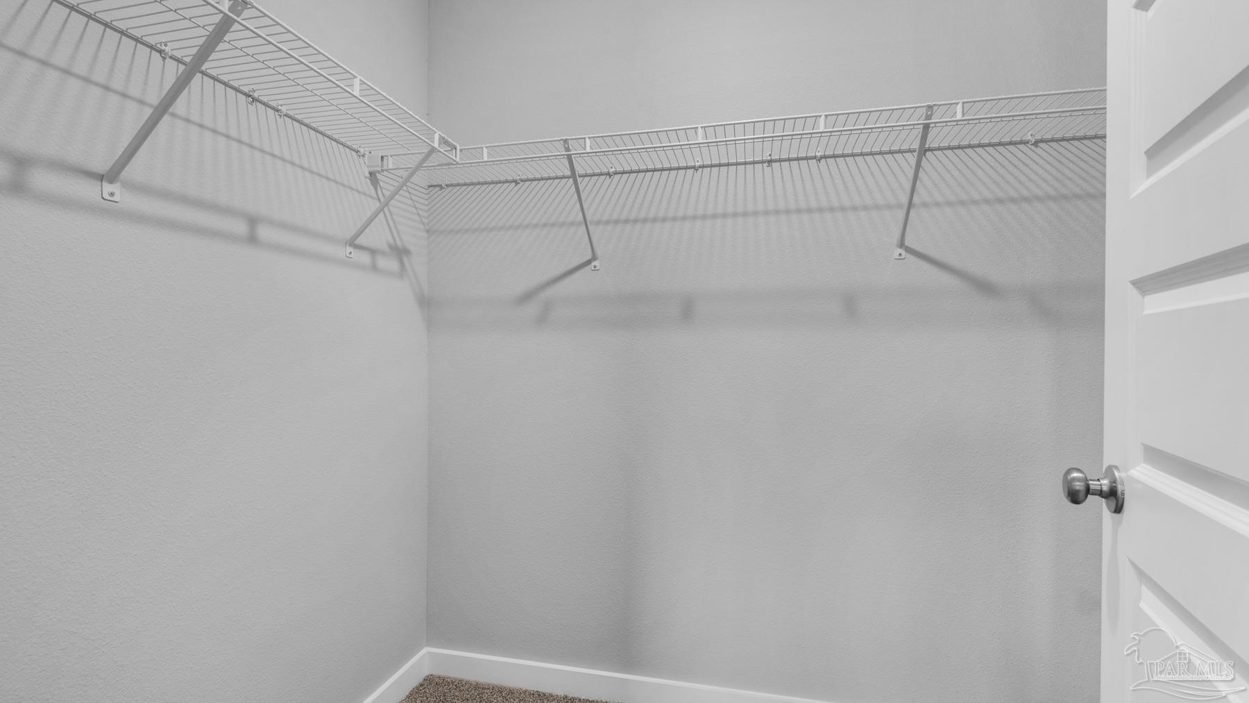 8 Spoonbill Street Cantonment, FL 32533 - Photo 22 of 38 a view of a room with racks on the wall