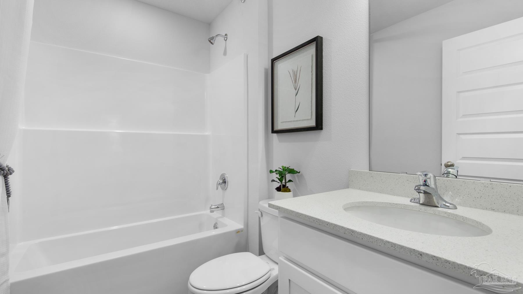 8 Spoonbill Street Cantonment, FL 32533 - Photo 28 of 38 a bathroom with a granite countertop sink toilet and shower