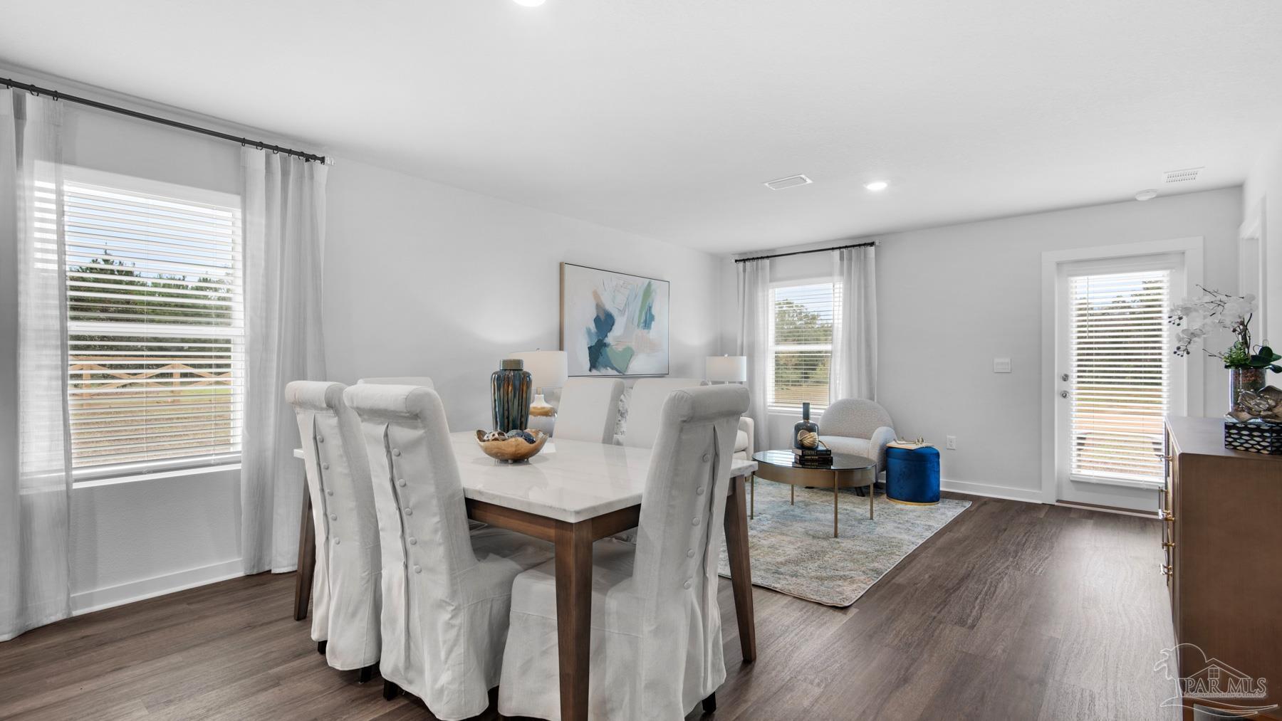 8 Spoonbill Street Cantonment, FL 32533 - Photo 7 of 38 a view of a dining room with furniture window and wooden floor