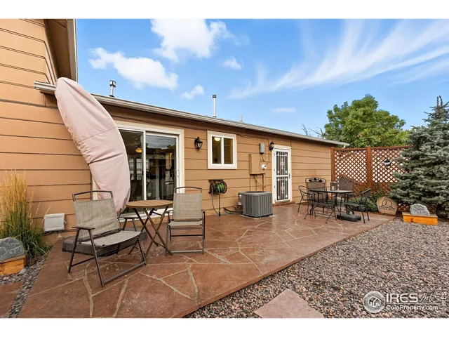 a backyard of a house with table and chairs