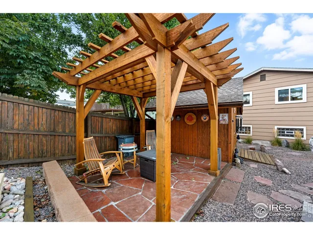 a view of a chairs and table in the back yard of the house