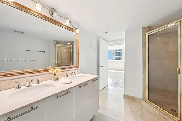 a bathroom with a sink double vanity and a mirror