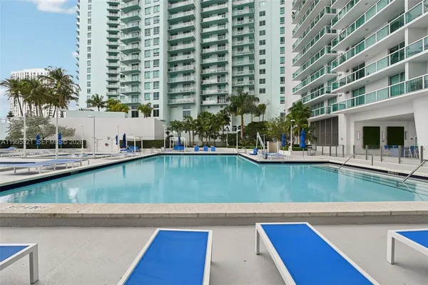 a view of swimming pool with chairs