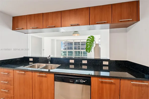 a kitchen with granite countertop cabinets and window