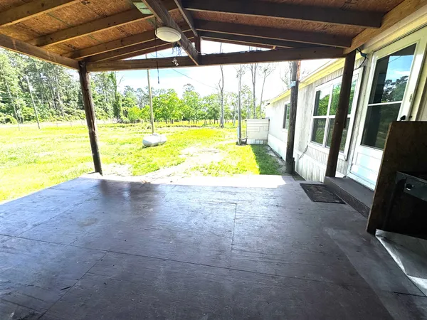 a view of empty room with window and front door
