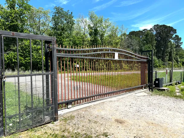 a view of a backyard with a iron fence
