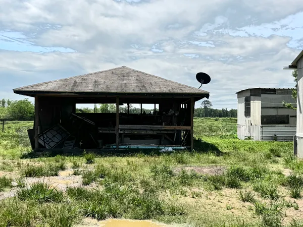 a view of house with backyard and garden