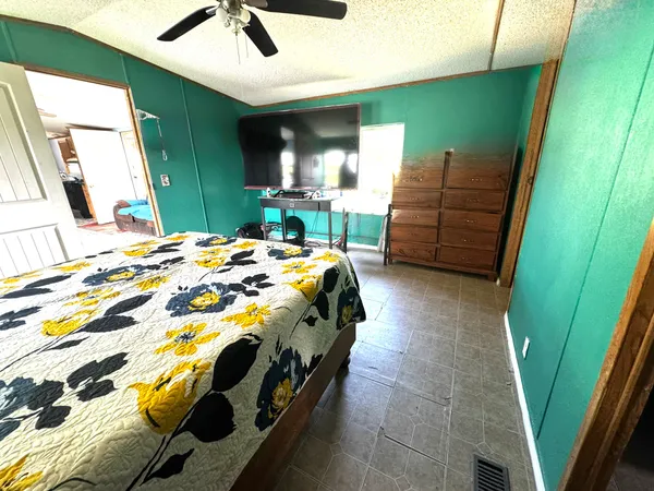 a bedroom with a bed and a large window