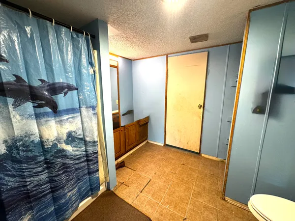 a bathroom with a glass door shower