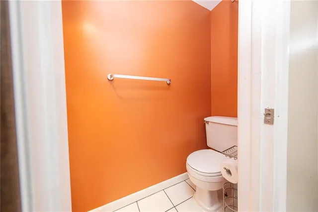 a white toilet sitting next to a shower