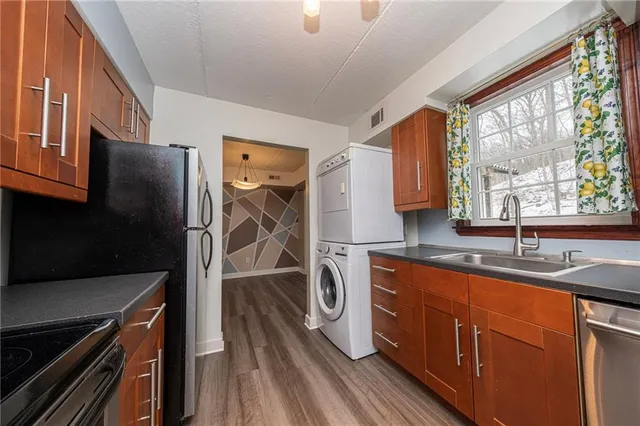 a kitchen with a sink stove and refrigerator