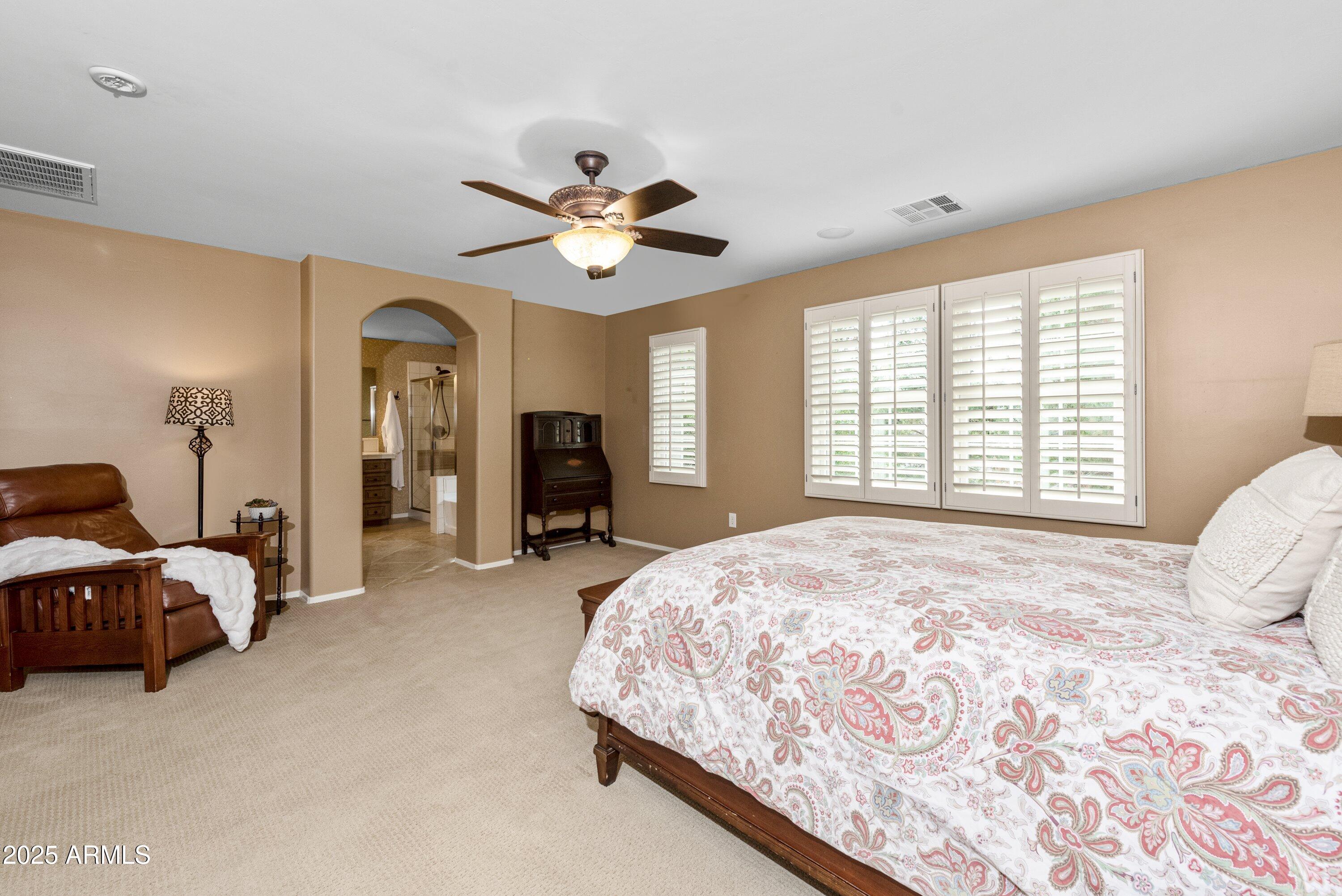 964 South Henry Lane Gilbert, AZ 85296 - Photo 23 of 48 a spacious bedroom with a bed and a chandelier