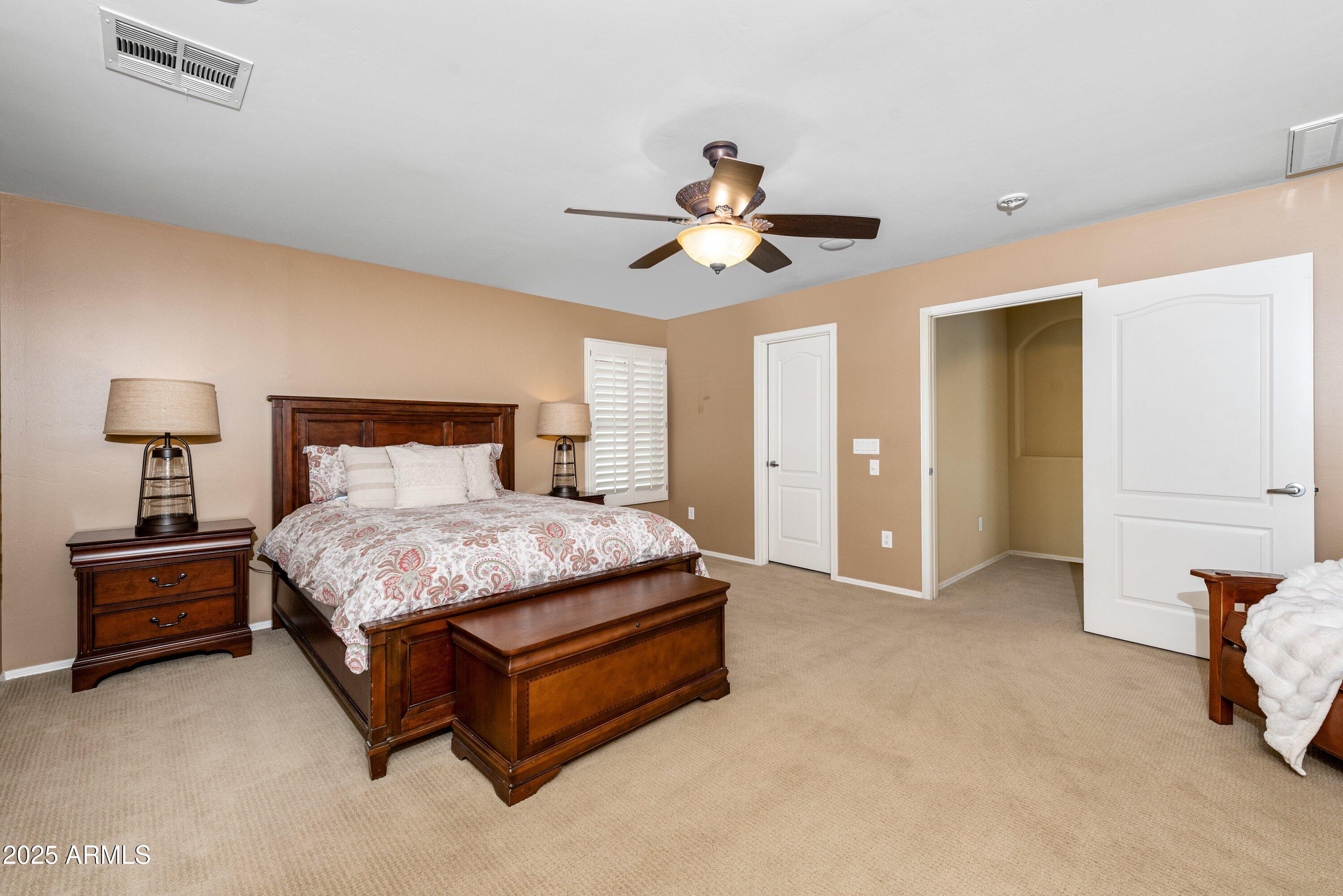 964 South Henry Lane Gilbert, AZ 85296 - Photo 24 of 48 a bedroom with a bed and a chandelier