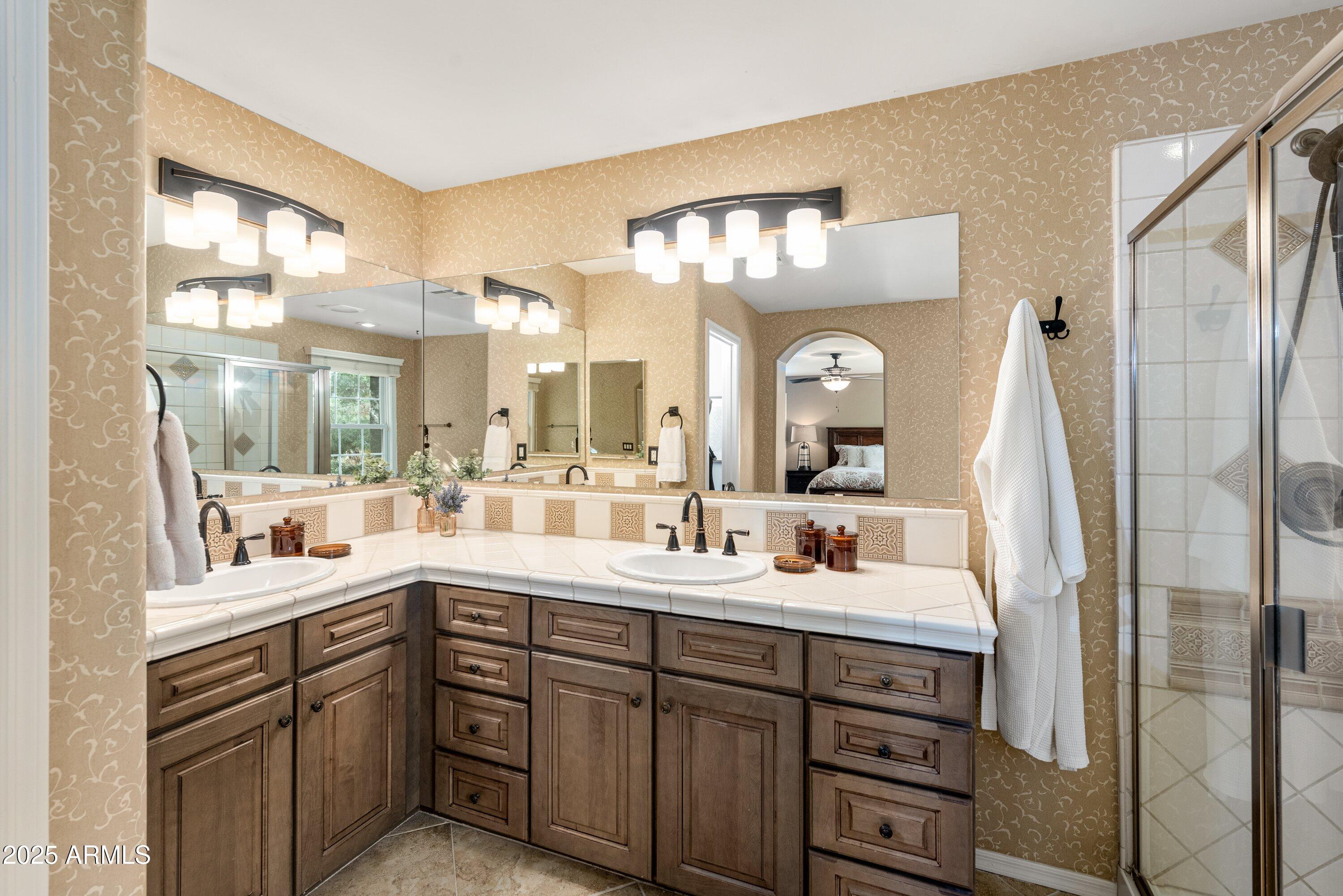 964 South Henry Lane Gilbert, AZ 85296 - Photo 25 of 48 a en suite bathroom with a double vanity sink and a mirror