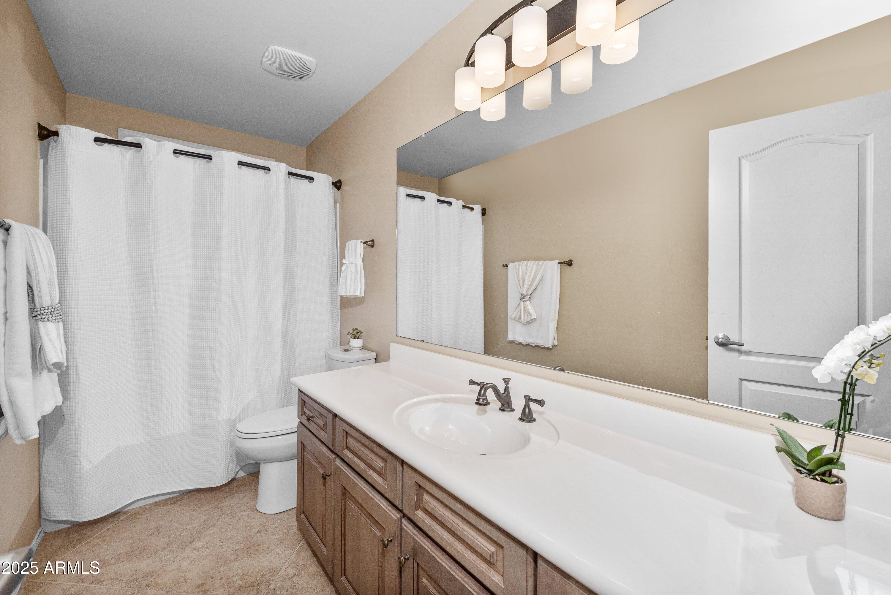 964 South Henry Lane Gilbert, AZ 85296 - Photo 28 of 48 a bathroom with a double vanity sink mirror and toilet