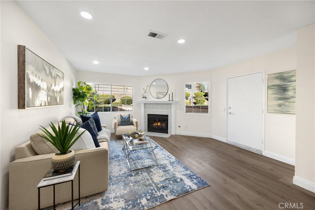 7268 Hermosa Avenue Rancho Cucamonga, CA 91701 - Photo 14 of 50 a living room with furniture a fireplace and a potted plant
