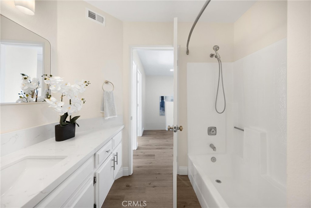 7268 Hermosa Avenue Rancho Cucamonga, CA 91701 - Photo 28 of 50 a bathroom with a double vanity sink a mirror a bathtub and shower