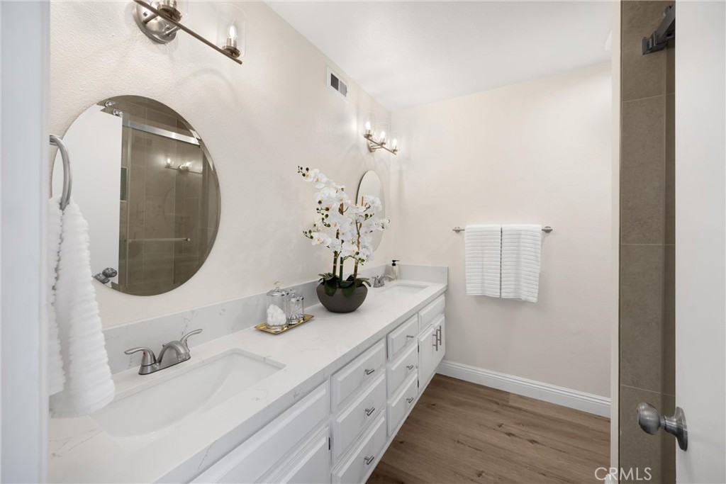7268 Hermosa Avenue Rancho Cucamonga, CA 91701 - Photo 32 of 50 a bathroom with a double vanity sink and a mirror