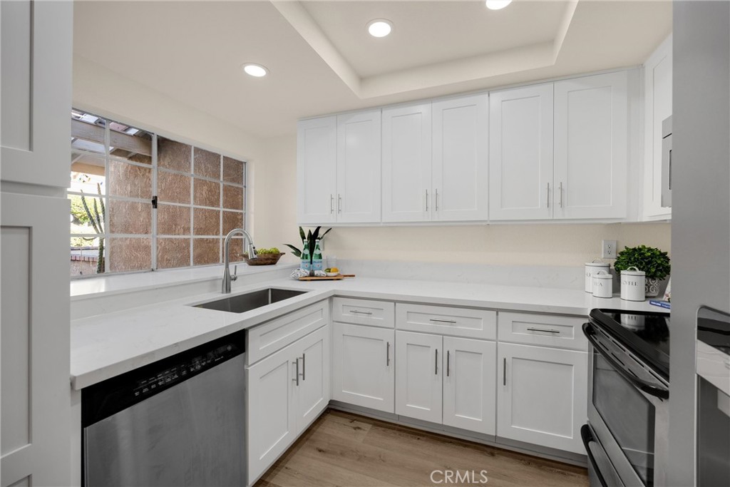 7268 Hermosa Avenue Rancho Cucamonga, CA 91701 - Photo 8 of 50 a kitchen with a sink white cabinets and white appliances
