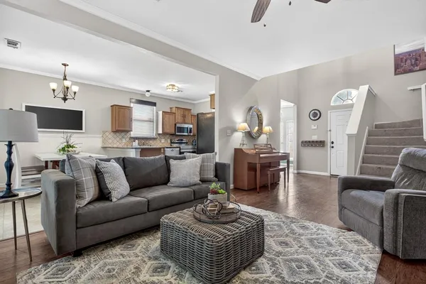 a living room with furniture a flat screen tv and a fireplace