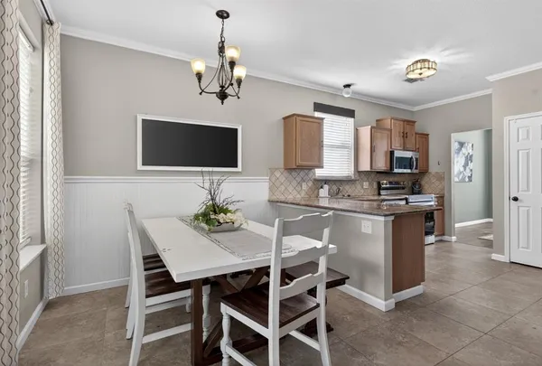 a kitchen with stainless steel appliances granite countertop a sink dishwasher a stove and a microwave oven with cabinets