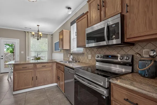 a kitchen with a sink stove and window