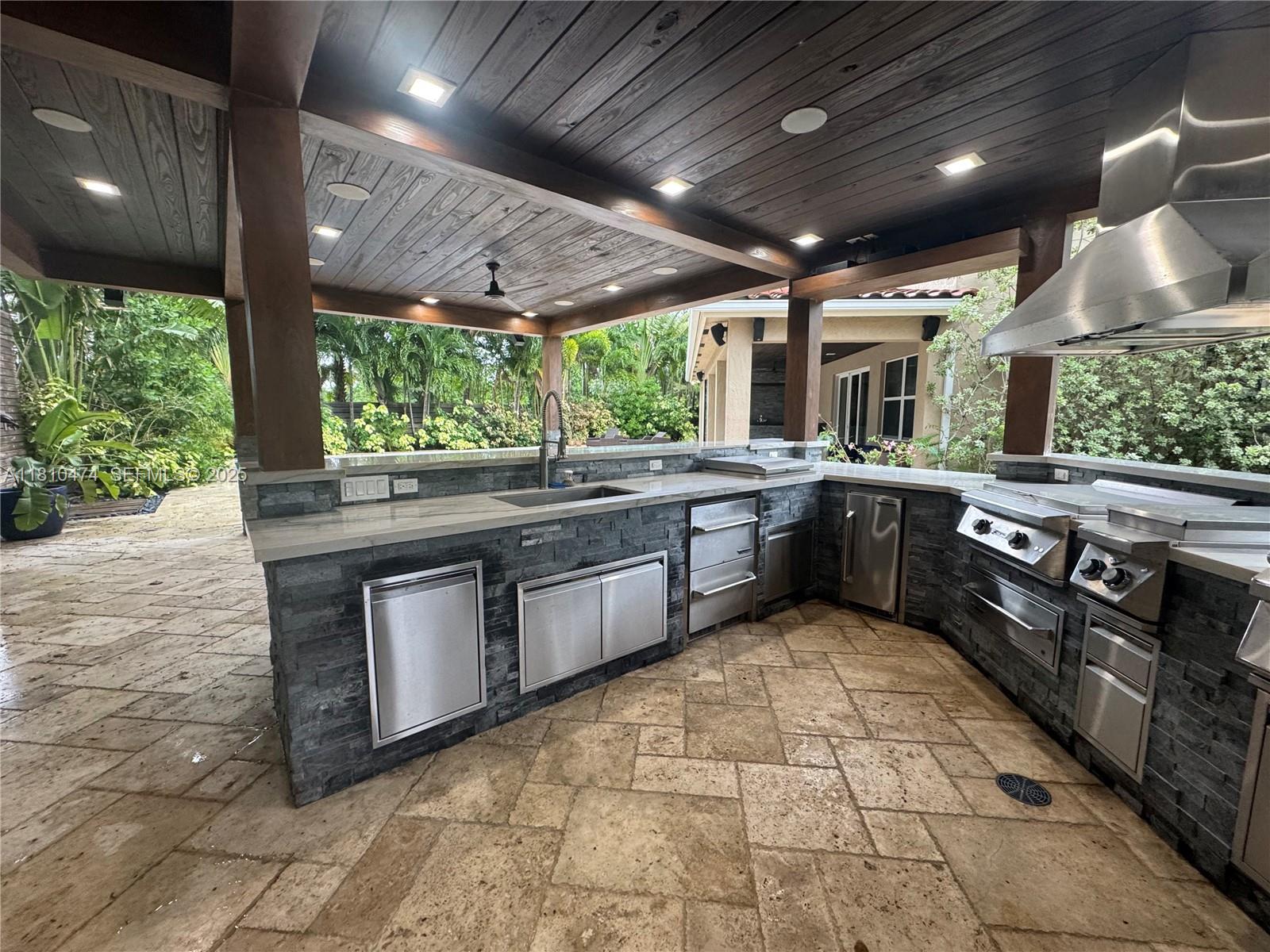2230 Northwest 17th Avenue Homestead, FL 33030 - Photo 29 of 31 a large kitchen with stainless steel appliances granite countertop a sink a stove and a wooden floors