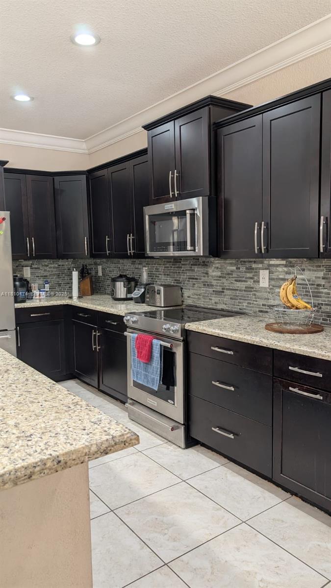 2230 Northwest 17th Avenue Homestead, FL 33030 - Photo 4 of 31 a kitchen with stainless steel appliances kitchen island granite countertop a sink stove and cabinets