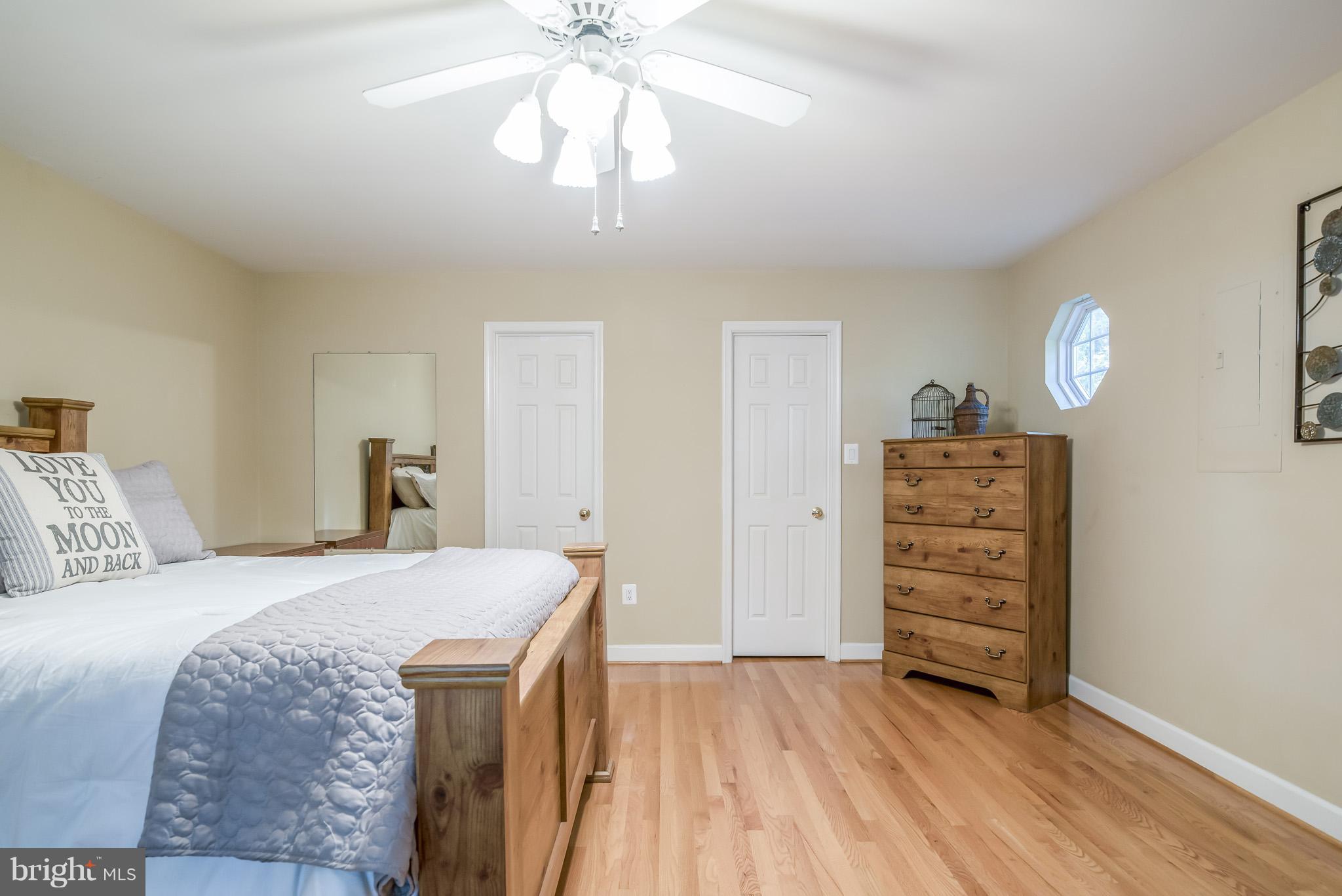 3 Ridgeview Circle Fredericksburg, VA 22406 - Photo 17 of 30 a bedroom with a bed and a chandelier