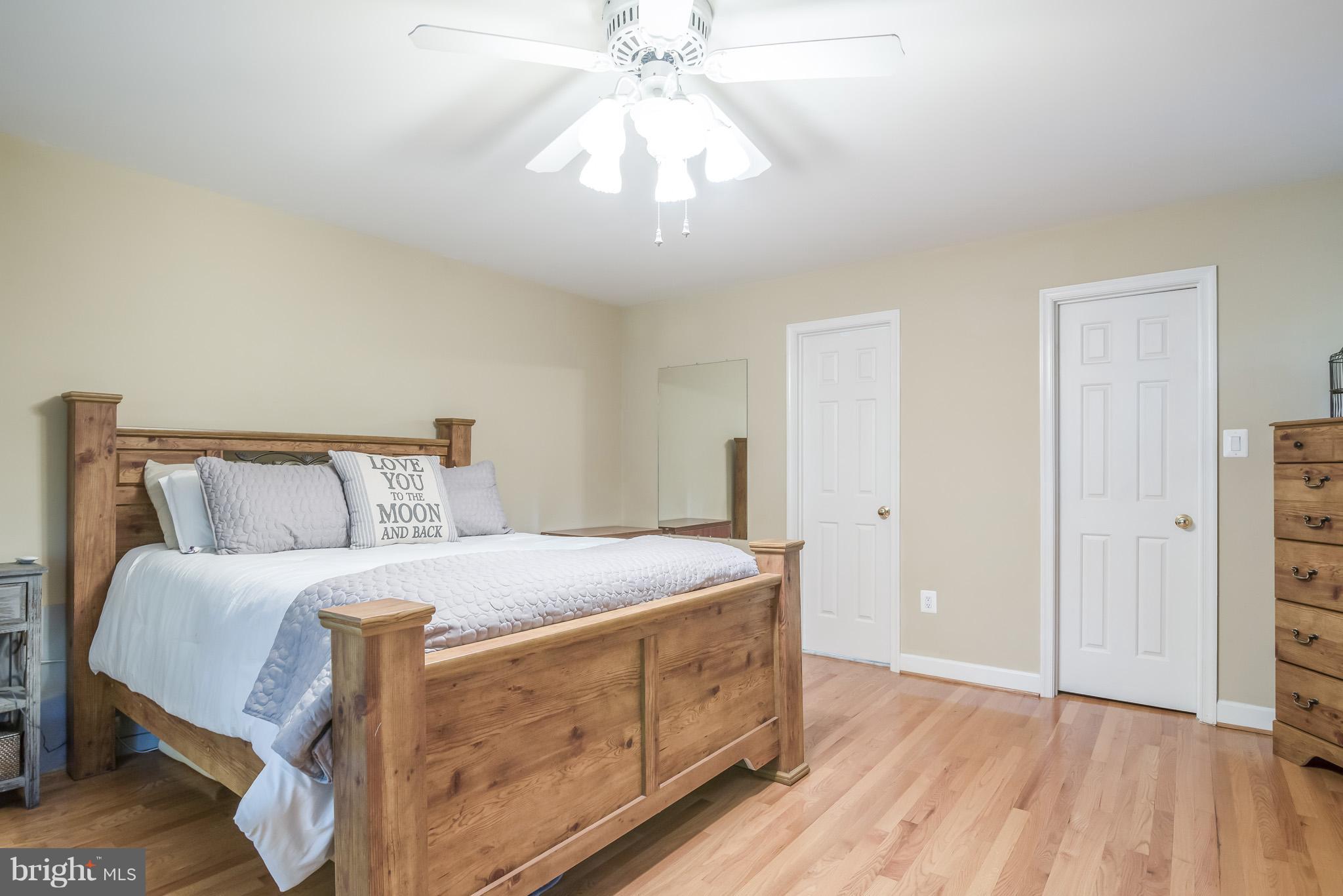 3 Ridgeview Circle Fredericksburg, VA 22406 - Photo 18 of 30 a bedroom with a bed and a chandelier