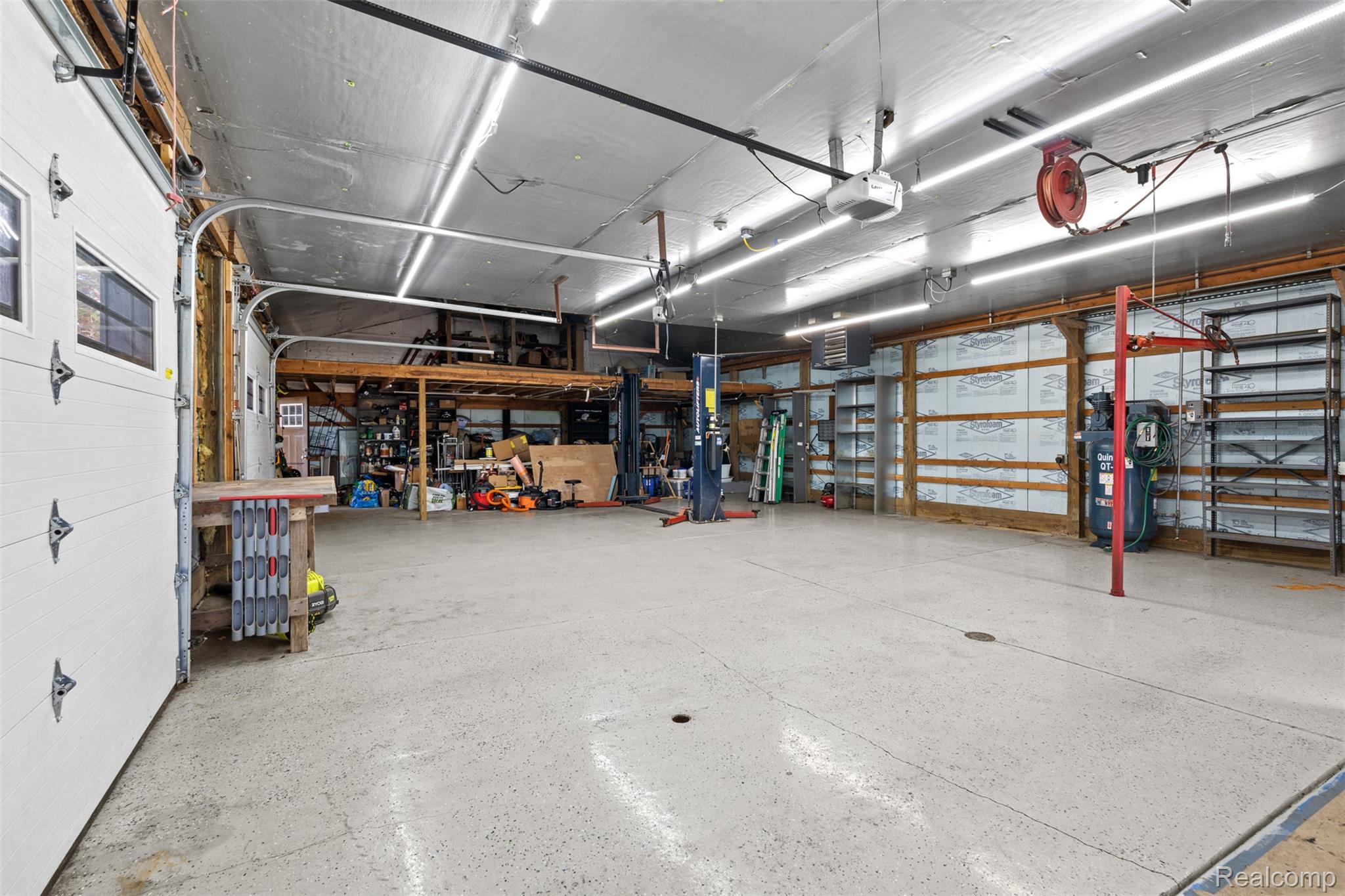 7670 Mi State Road Manchester, MI 48158 - Photo 43 of 53 Garage with a workshop area and a garage door opener