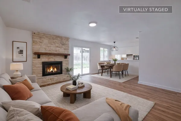 a living room with furniture and a fireplace