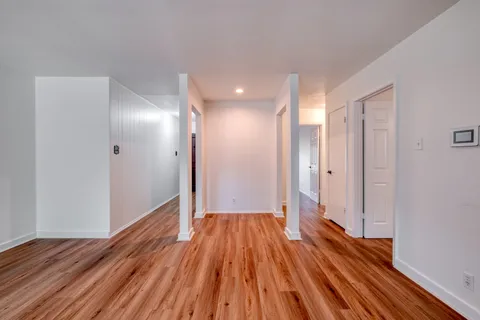 a view of hallway with wooden floor