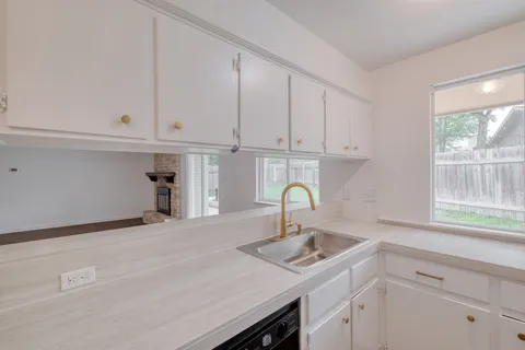a kitchen with a sink and cabinets