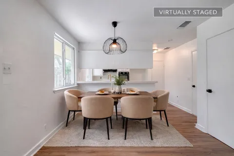 a view of a dining room with furniture window and wooden floor